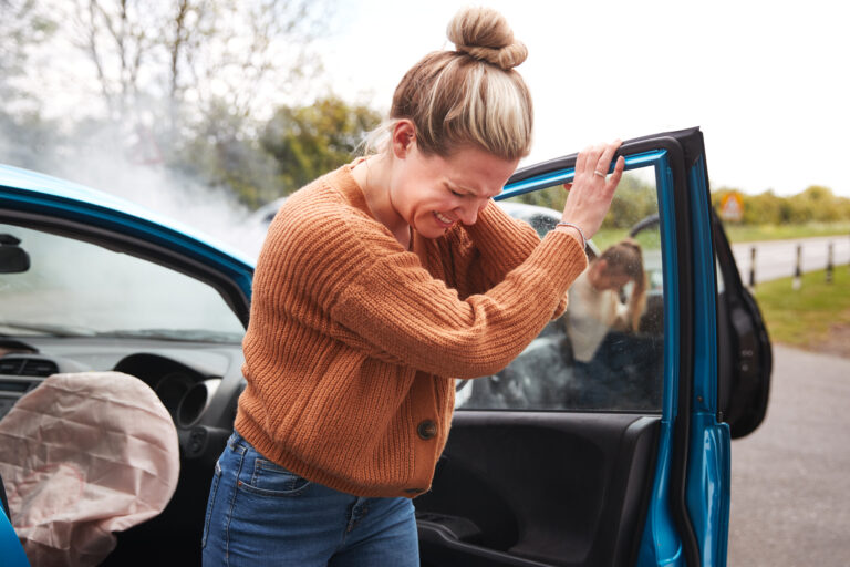 Female Motorist In Crash For Crash Insurance Fraud Getting Out Of Car