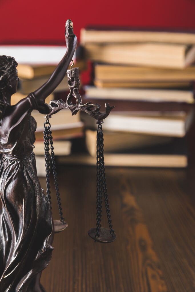 statue lady justice on wooden table with books, law concept