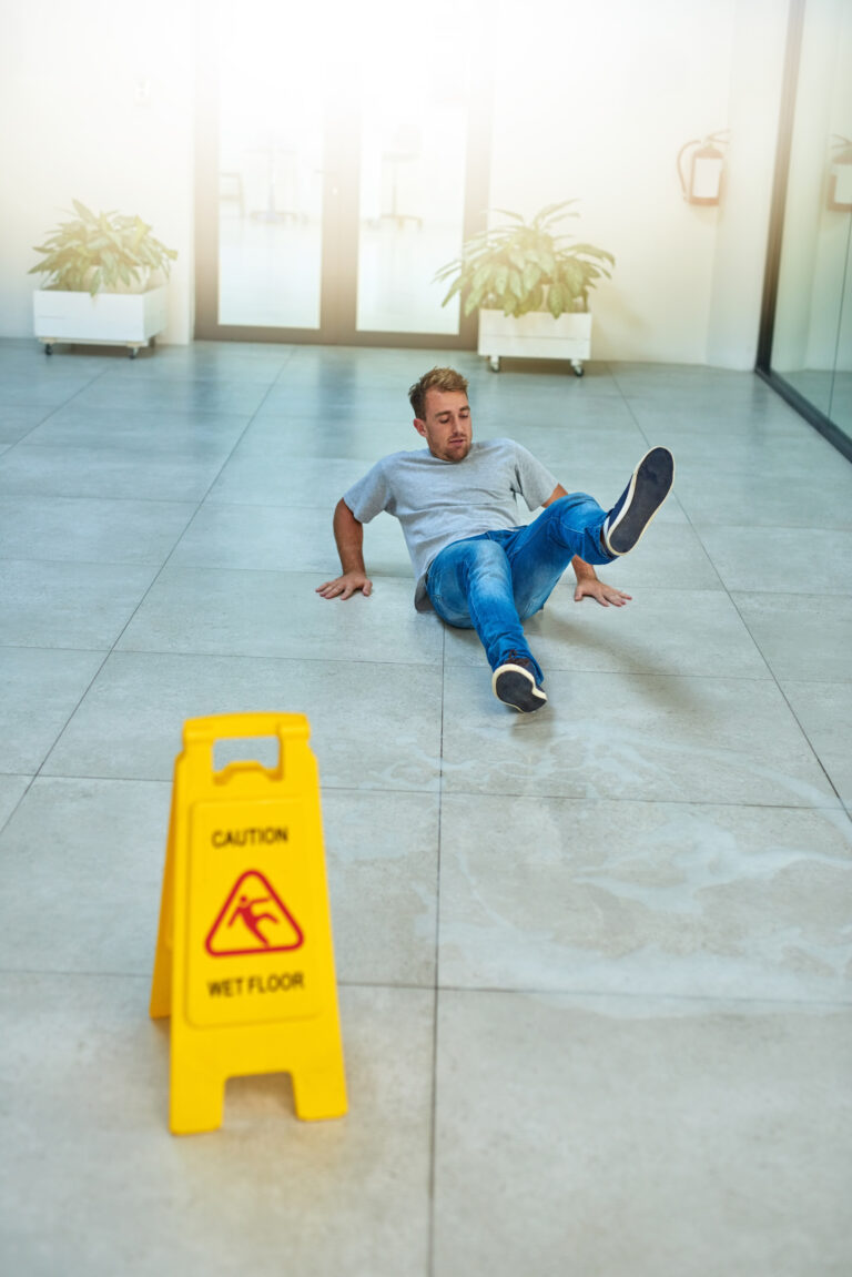 He didnt read the sign. Shot of a man cleaning an office buildin